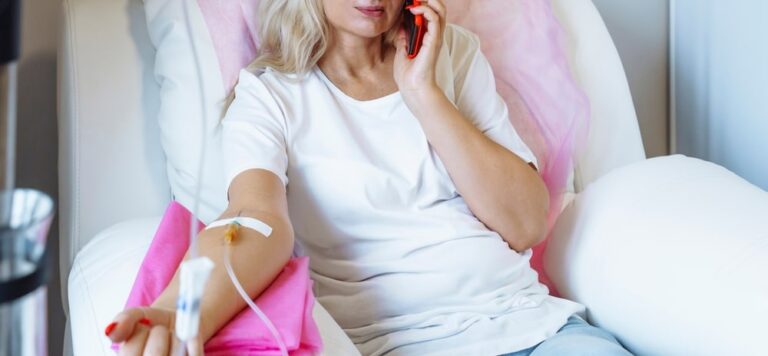 Woman receiving iv drip whilst relaxing