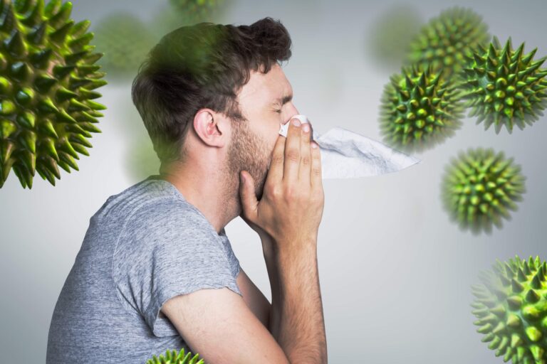 Man sneezing due to weak immune system